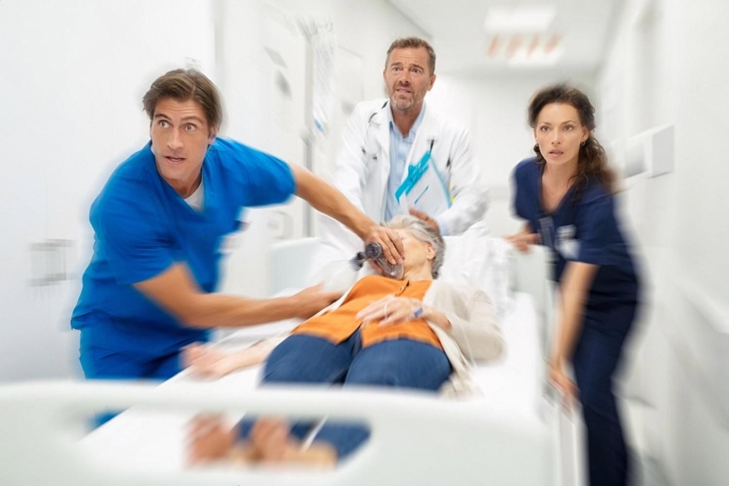 Emergency medical team rushing a patient on a hospital trolley through a UAE hospital corridor