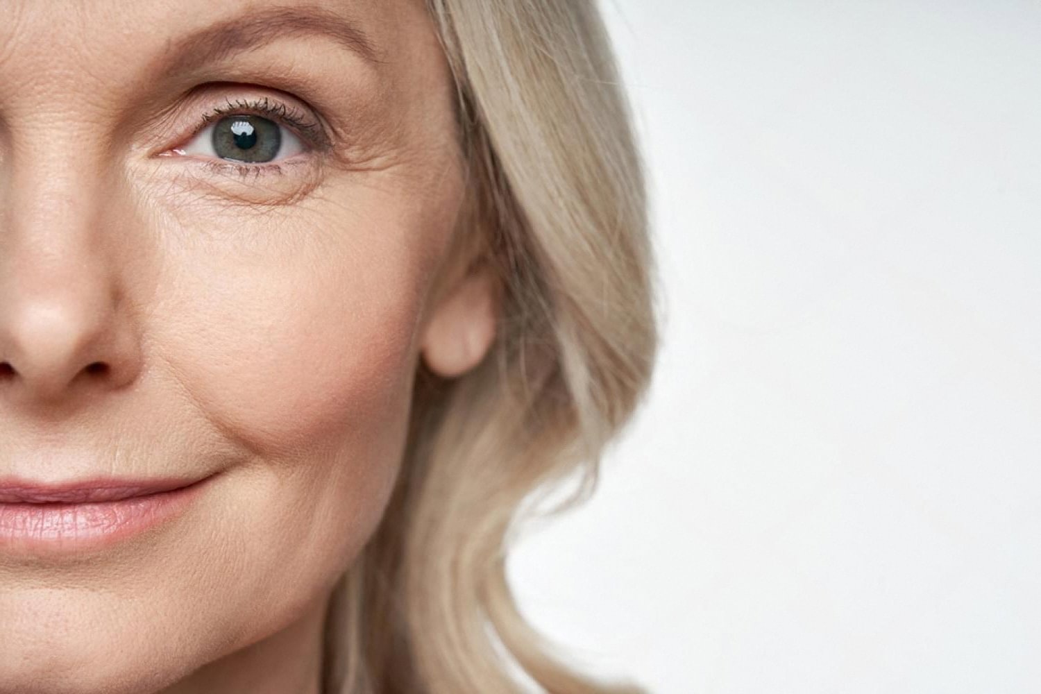 Close-up of a woman's face showing fine lines around the eye, a common sign of premature skin aging